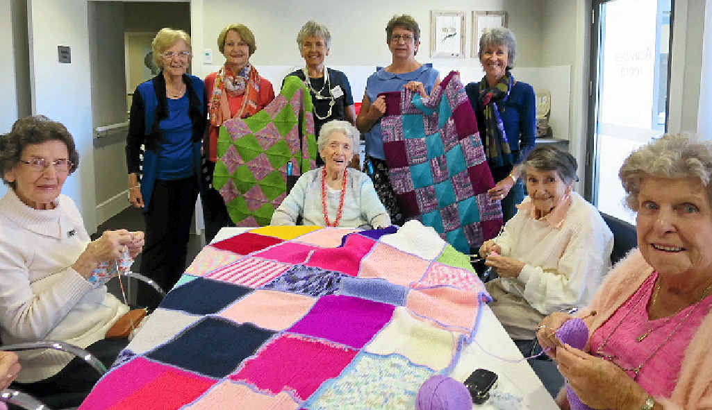 A group of residents and volunteers knitting and nattering. A group of residents and volunteers knitting and nattering.